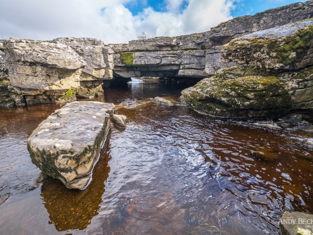 The river Greta flowing under the limestone arch of God's Bridge, Teesdale