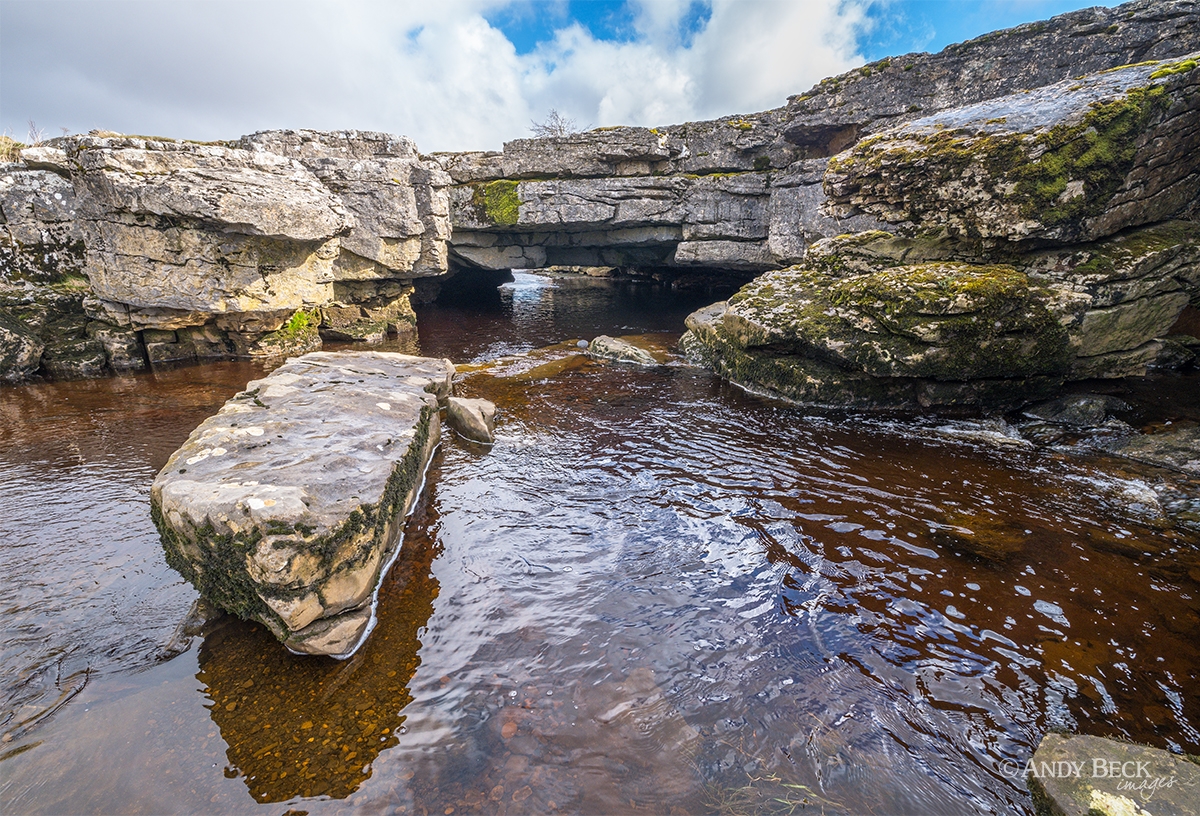 The river Greta flowing under the limestone arch of God's Bridge, Teesdale