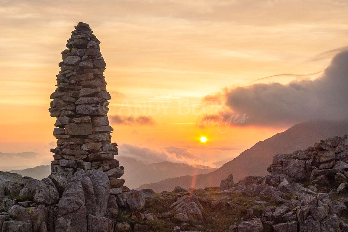 Lingmell sunrise, the first rays of the sun reach the rocky top of Lingmell, Scafell Pikes