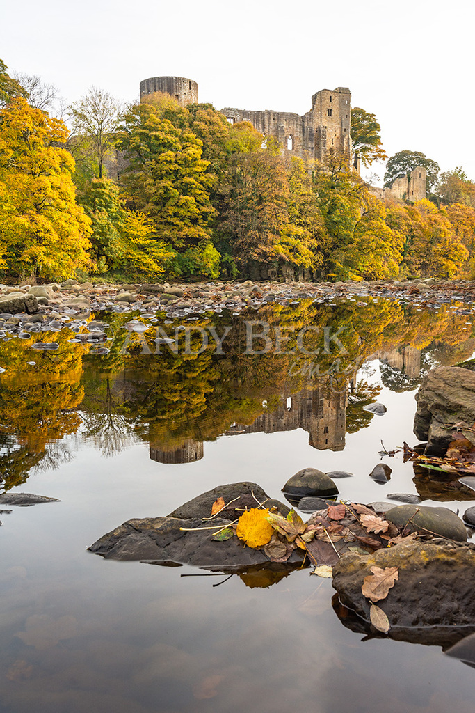 Barnard Castle reflected in the calm waters of the river Tees
