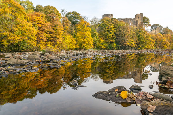 Barnard Castle reflected in the still waters of the river tees