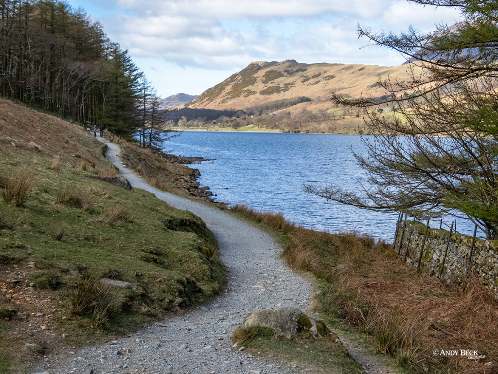The footpath around Buttermere Lake in the Lake District with Rannerdale Knotts in the distance